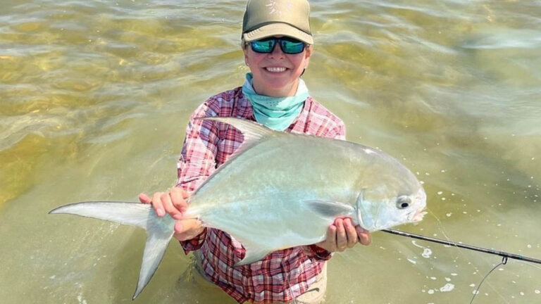 An inshore fly fishermen catches a permit in Ascension Bay, Mexico.