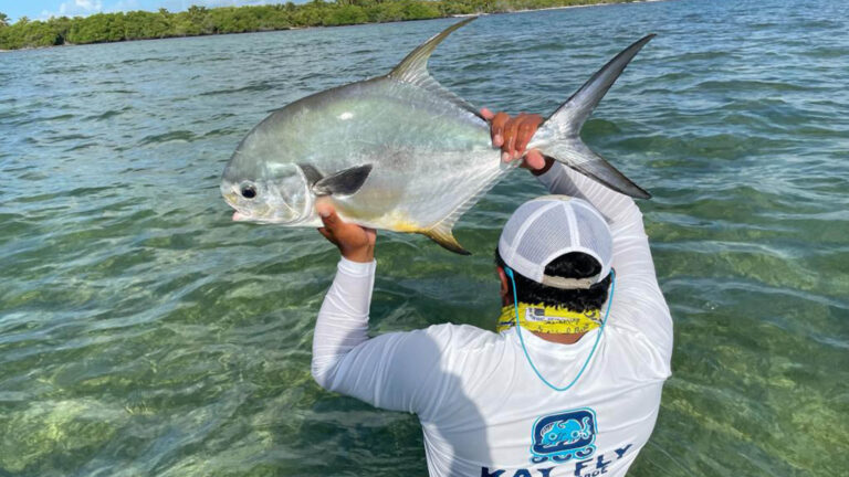 An inshore fly fishermen catches a permit in Ascension Bay, Mexico.